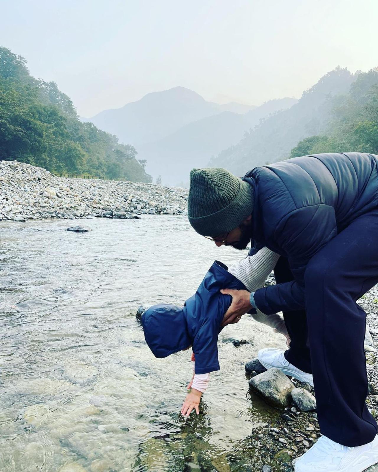 This cute photo where Virat and Vamika are playing with water near a stream has all our hearts. 